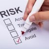 How to risk proof your small business Close-up Of A Woman's Hand Ticking Avoid Option On Risk Form With Marker